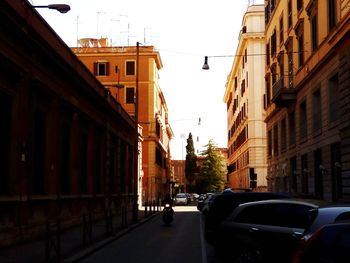 Cars on street amidst buildings in city