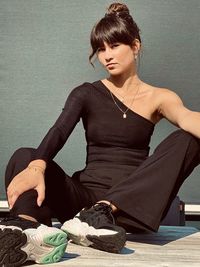Portrait of young woman sitting on table