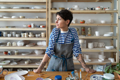 Entrepreneur crafts woman in pottery studio preparing for master class or work process