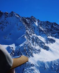 Scenic view of snowcapped mountains against clear blue sky