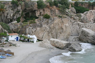 Scenic view of cliff by sea