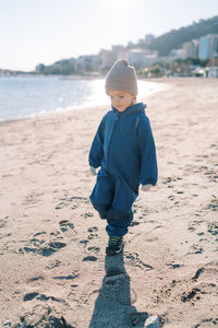 Boy standing at beach