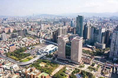 High angle view of modern buildings in city against sky