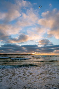 Scenic view of beach against sky during sunset