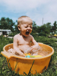 Full length of shirtless boy in water