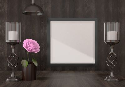 Flower vase on table against wall