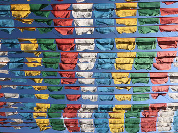 Full frame shot of colorful flags against clear blue sky