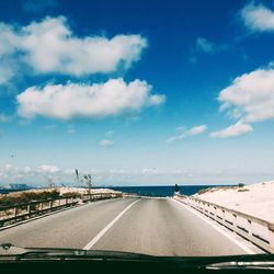 View of road against cloudy sky