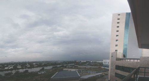 Buildings against cloudy sky