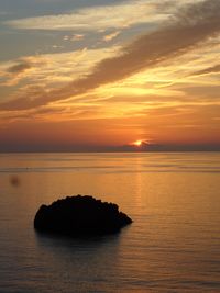 Scenic view of sea against romantic sky at sunset