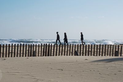 People on beach against sky