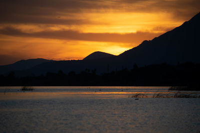 Scenic view of silhouette mountains against sky during sunset