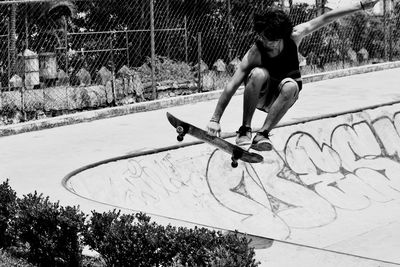 Full length of man skateboarding at skateboard park