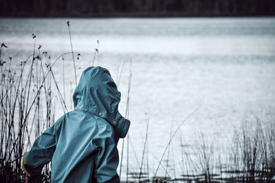 Rear view of person standing in rain