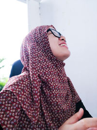 Smiling woman wearing eyeglasses and hijab