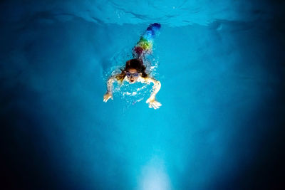 High angle view of boy swimming in pool