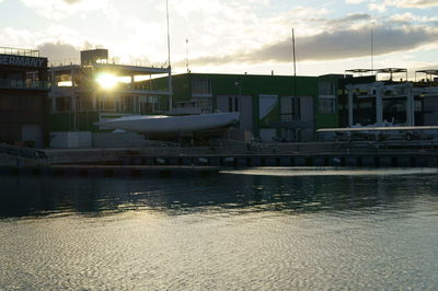 Boats moored at harbor against sky