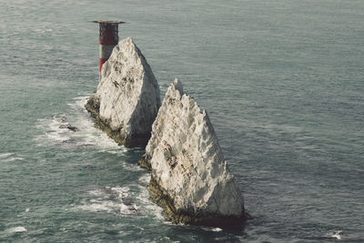 High angle view of rock formations amidst sea