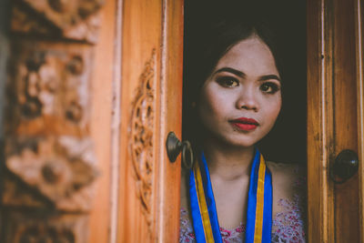 Portrait of young woman at entrance