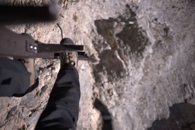 Low section of man climbing mountain