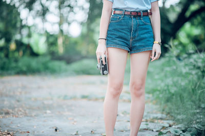 Low section of woman standing on ground