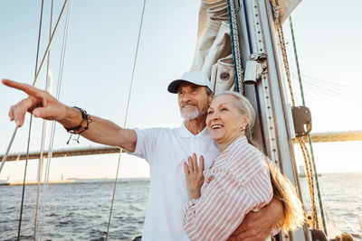 Senior couple on boat at sea against sky