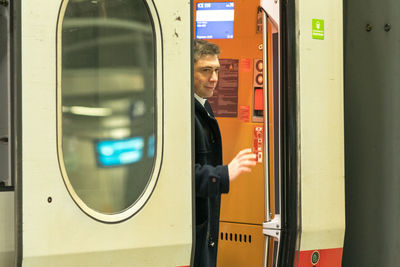 Reflection of man on train at railroad station