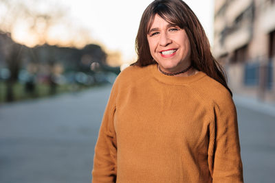 Portrait of transgender smiling on road