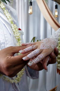 Midsection of couple holding hands