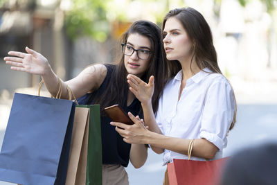 Young woman looking at camera while standing outdoors