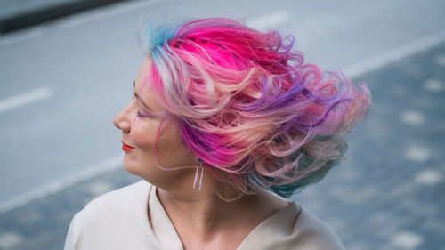 Close-up portrait of woman with pink hair