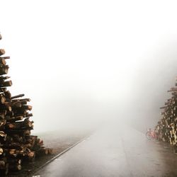 Road in foggy weather against sky during winter