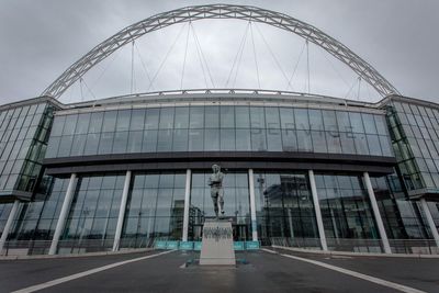 Low angle view of statue against wembley stadium