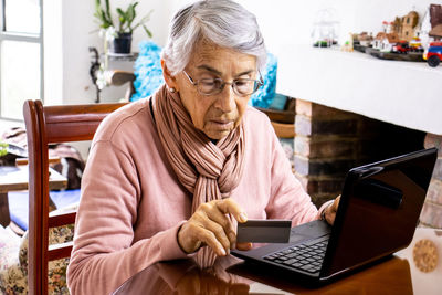 Senior woman online shopping through laptop