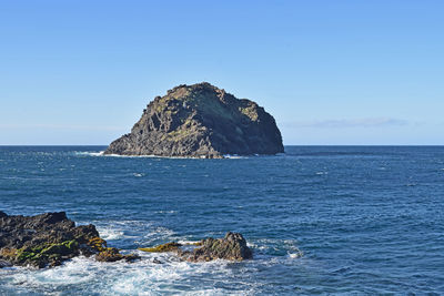 Scenic view of sea against clear blue sky