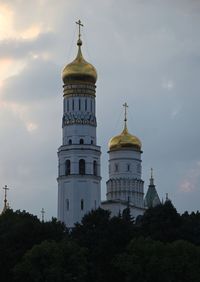 Church by building against sky