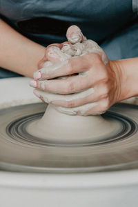 Midsection of woman at pottery workshop