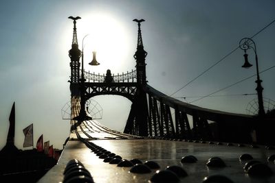 Low angle view of bridge against cloudy sky