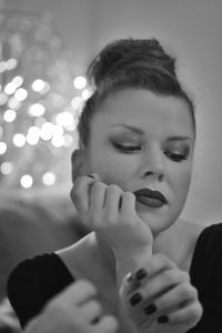 Close-up of woman with make-up looking down