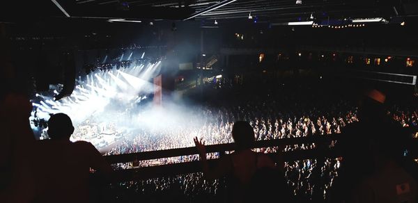 People enjoying music concert at night