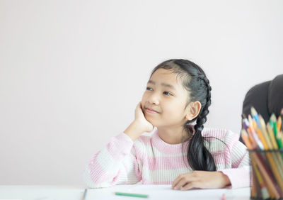 Portrait of a girl sitting on table