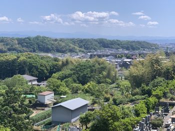 High angle view of trees and buildings against sky