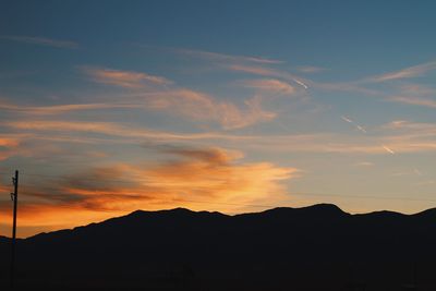 Low angle view of silhouette mountains against sky during sunset