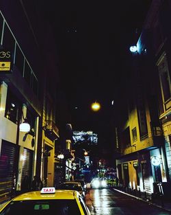 Illuminated city street at night