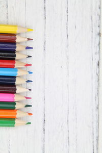 Close-up of colored pencils on white background