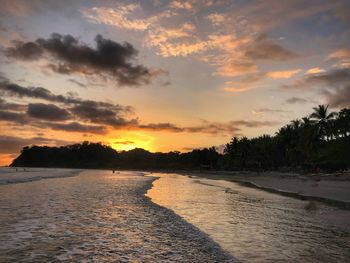 Scenic view of beach against sky during sunset