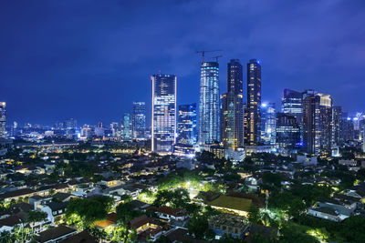 High angle view of city lit up at night