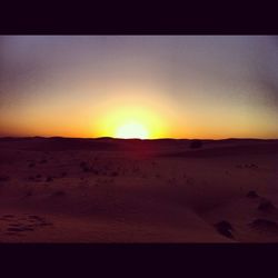 Scenic view of desert against sky during sunset