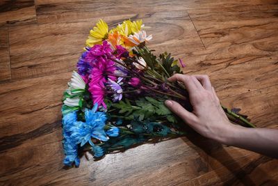 High angle view of person holding bouquet on floor