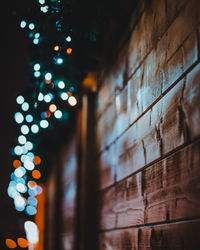 Low angle view of christmas lights by wall
